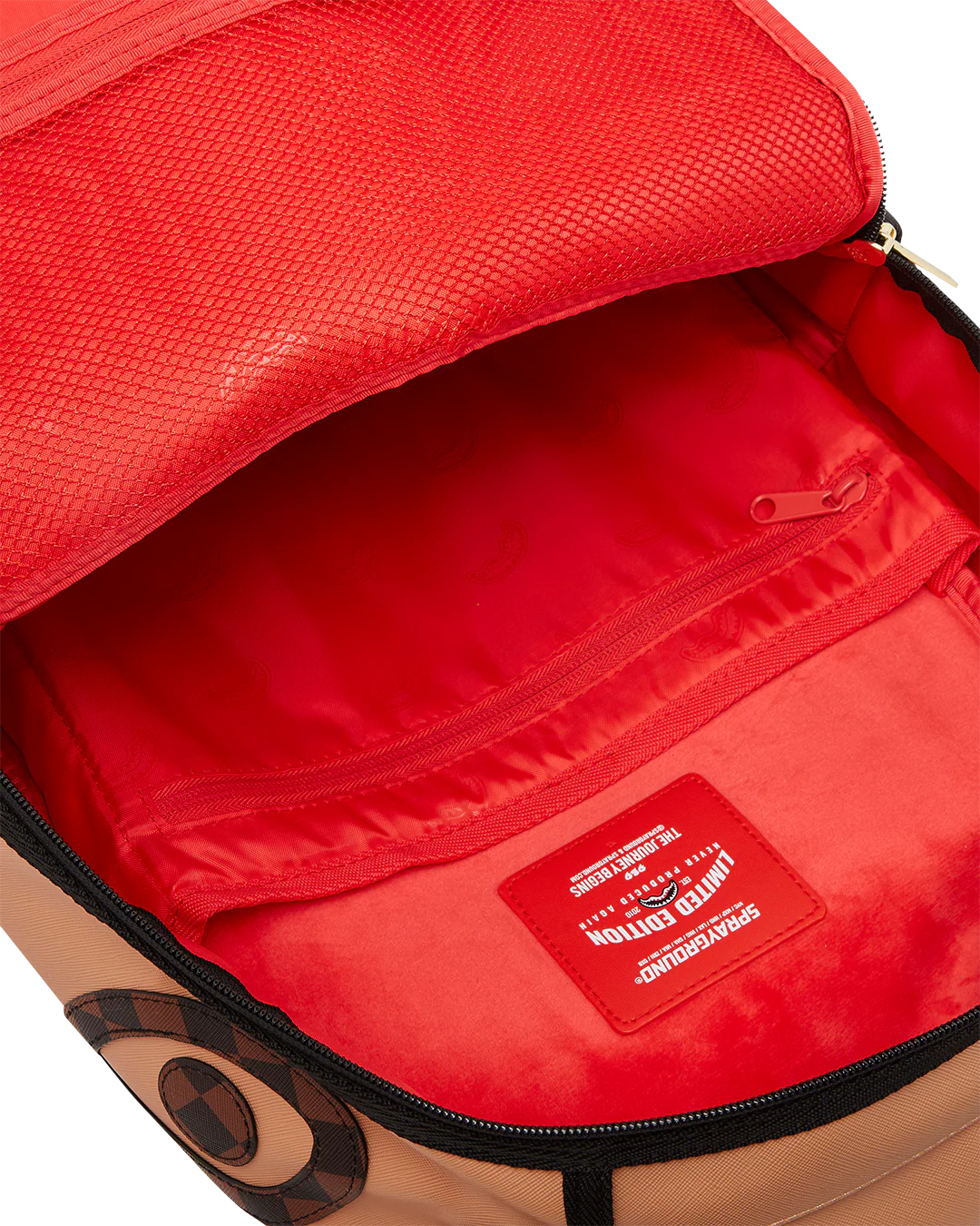Red interior of a backpack with a visible brand logo.
