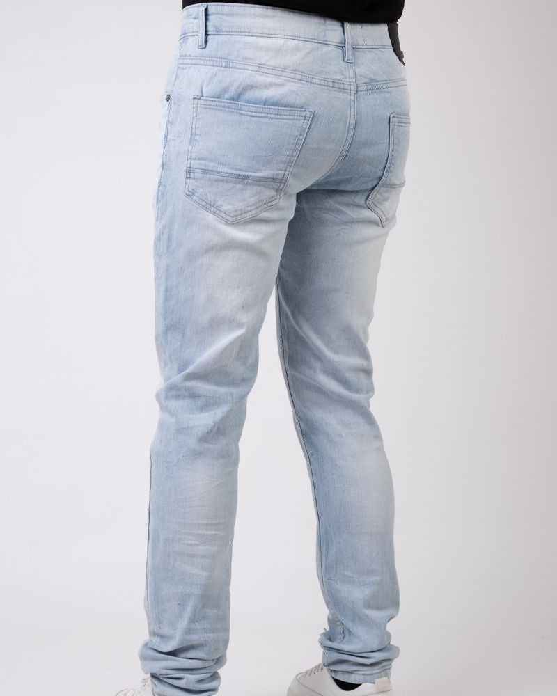 Light blue jeans worn by a person on a white background