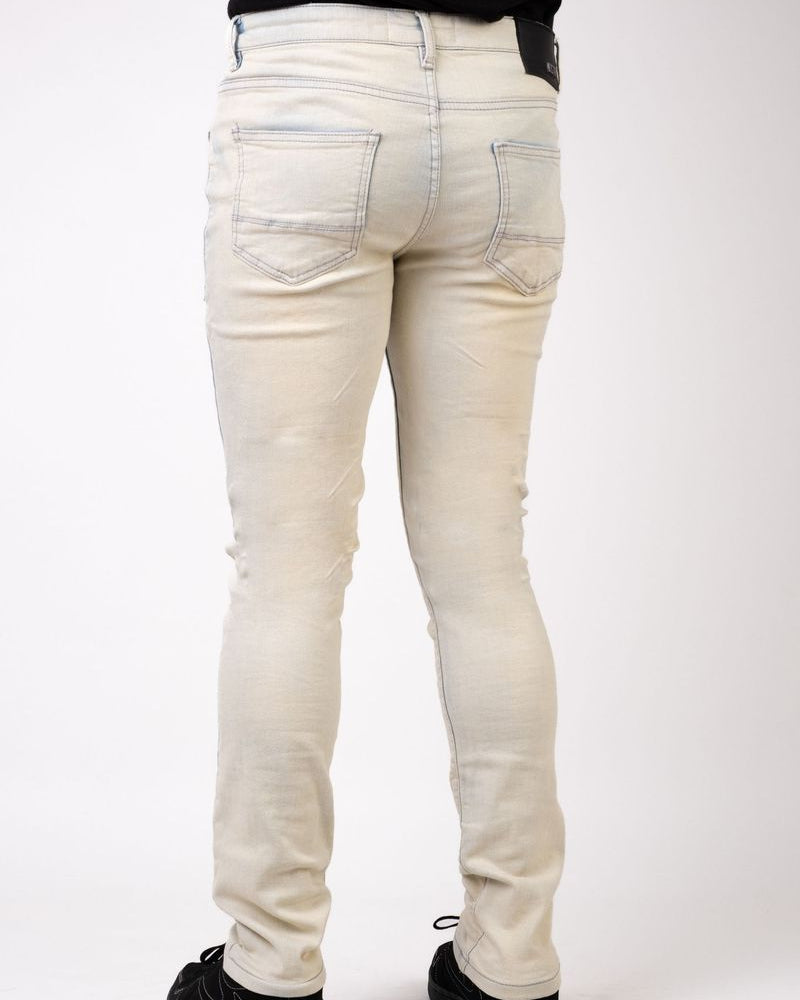 White jeans worn by a person on a white background
