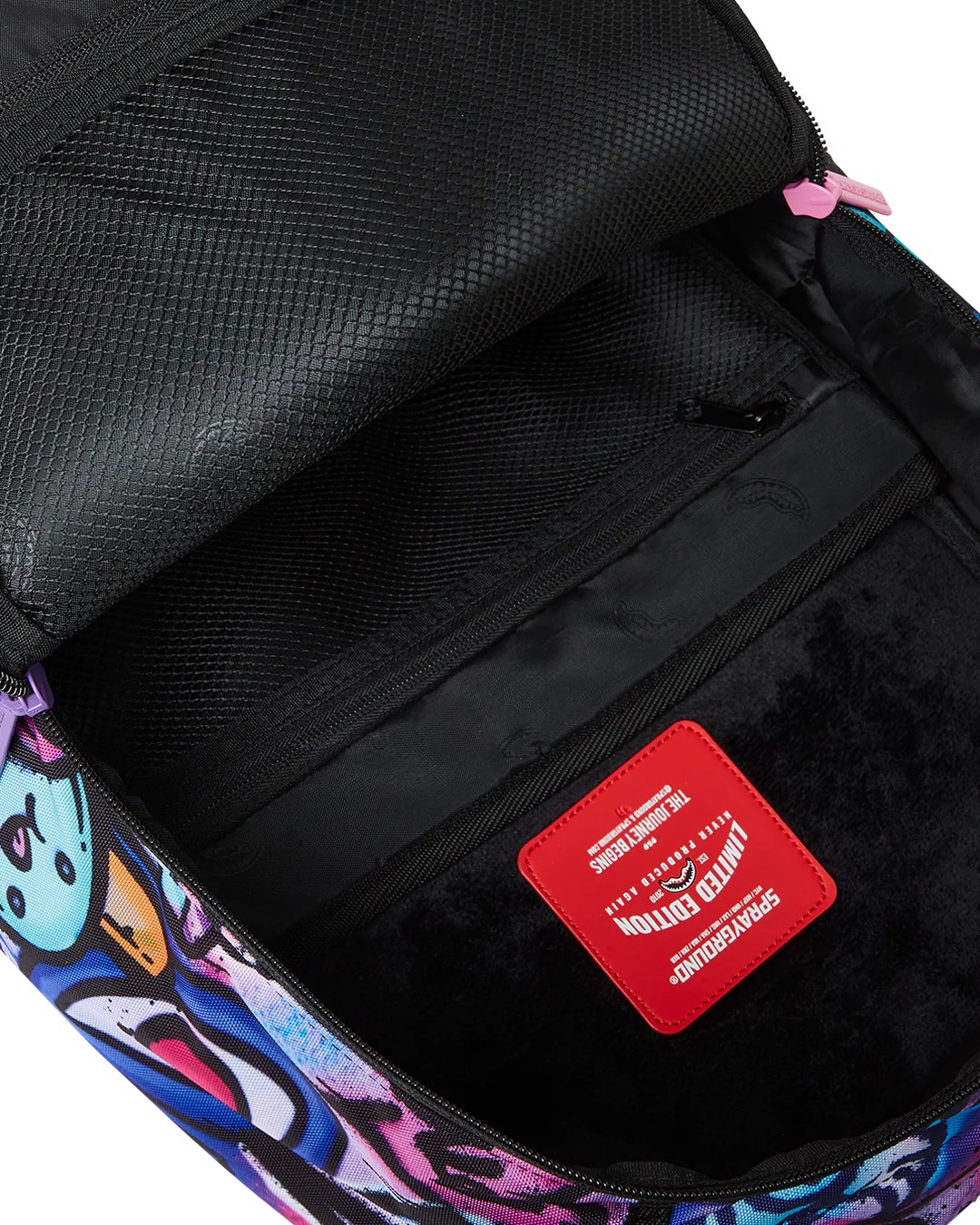 Backpack interior with colorful design and a red label on a black background