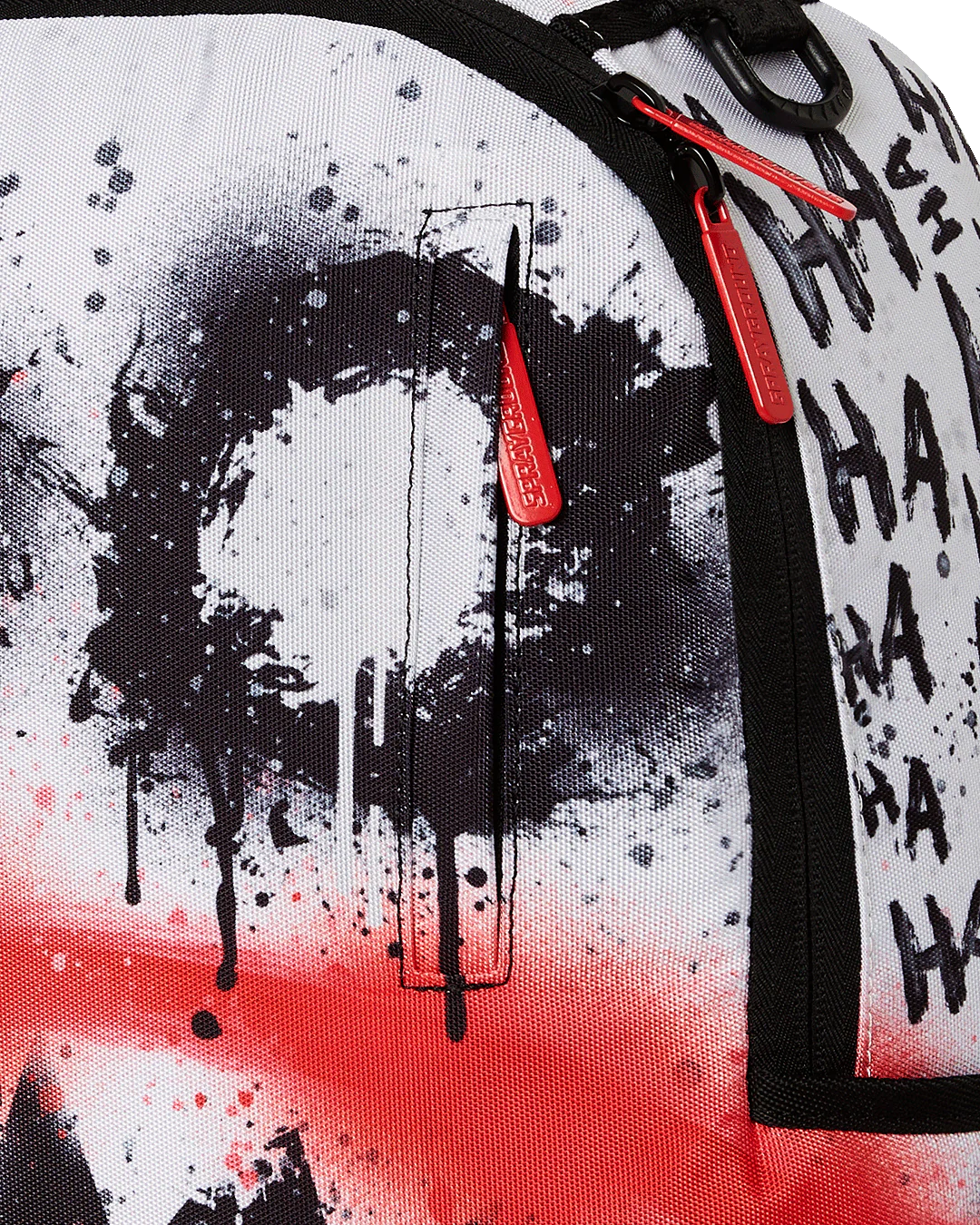 close up of a Backpack with black and white splatter design and red accents on a white background