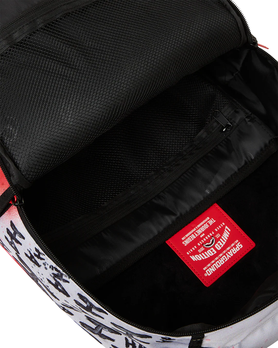 Close-up of a backpack interior with a red label and black lining.