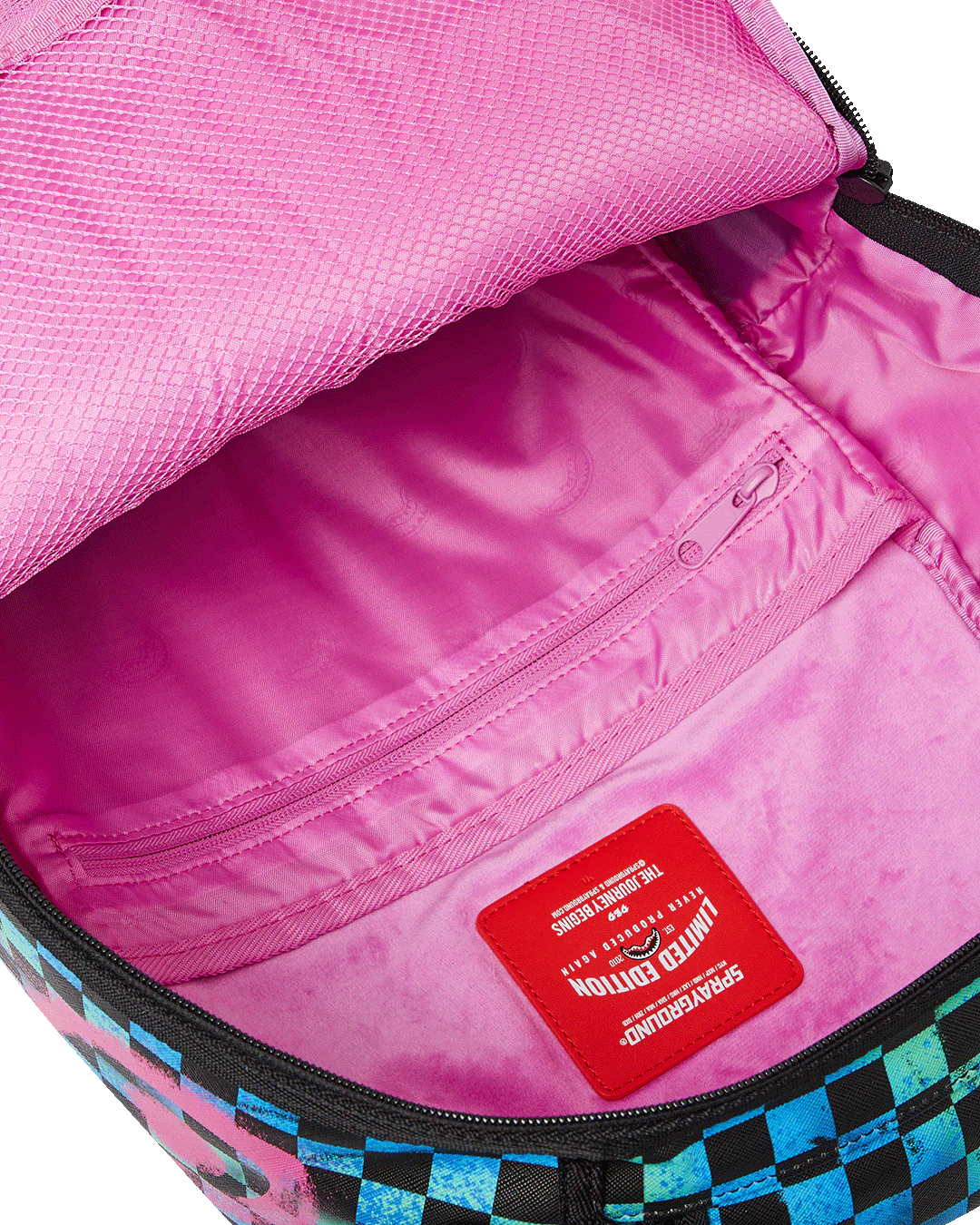 Pink bag interior with a red label inside, showing checkered pattern on edges.
