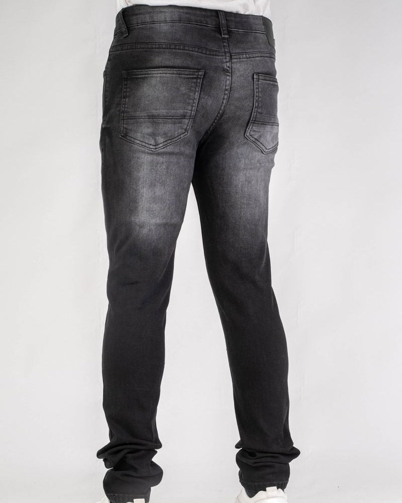 Black jeans worn by a person on a white background