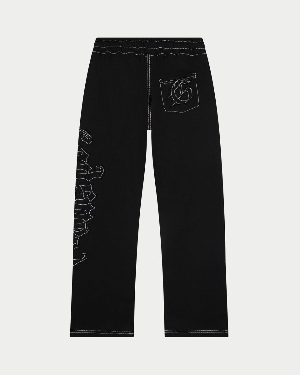 Black pants with white embroidery on a light gray background