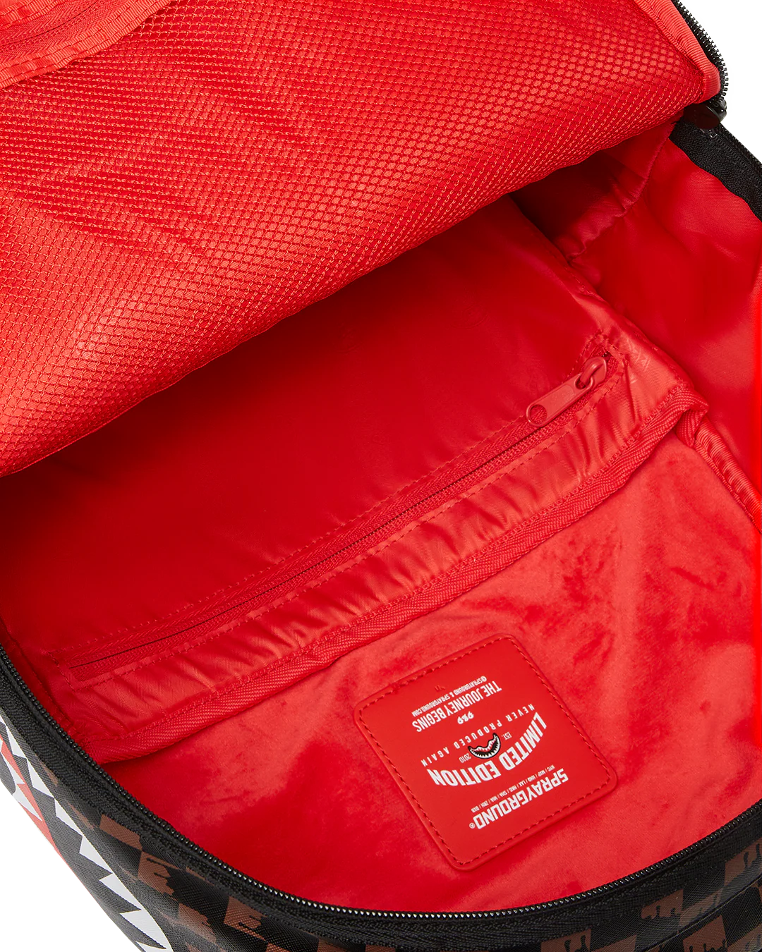 Close-up of a red interior bag with a visible brand label on a white background