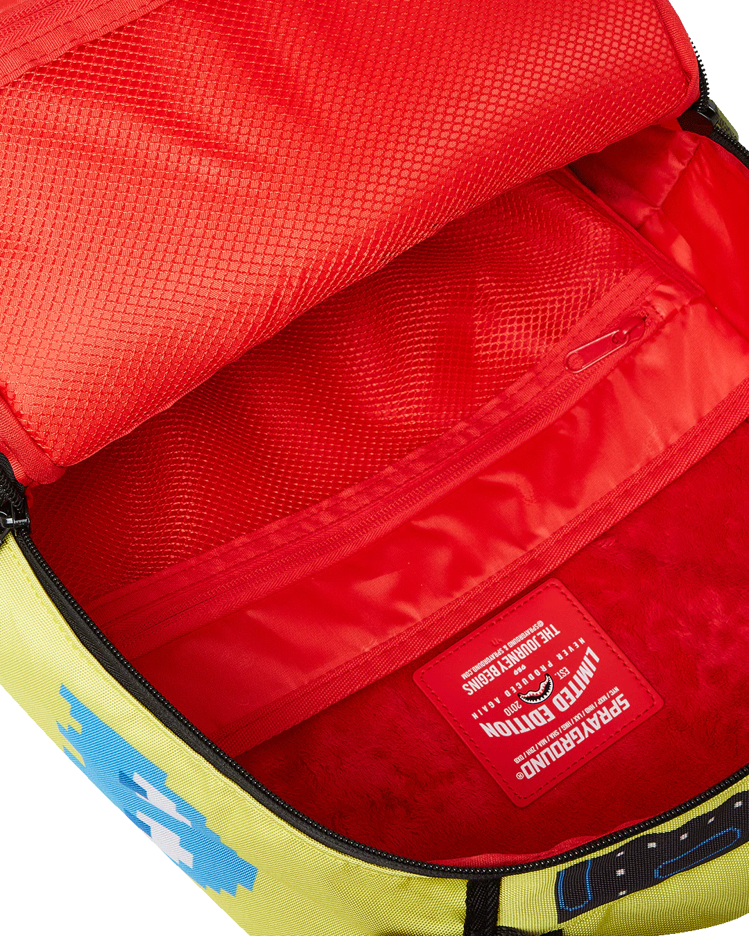 Close-up of a red and yellow bag interior with a brand label.