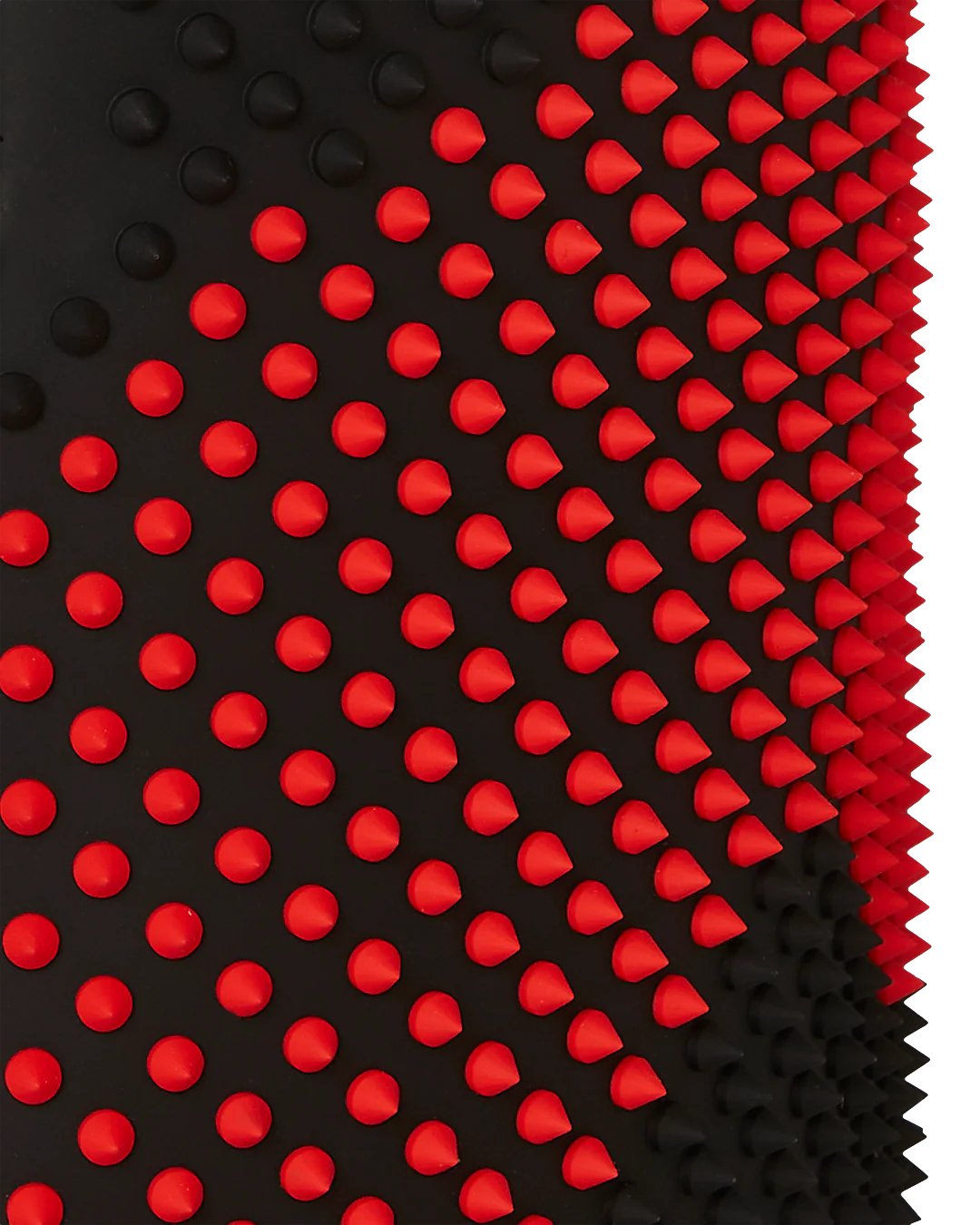Close-up of a black and red textured mat with red spikes on a white background