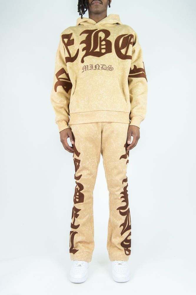 Beige hoodie and pants set with brown graphics on a white background
