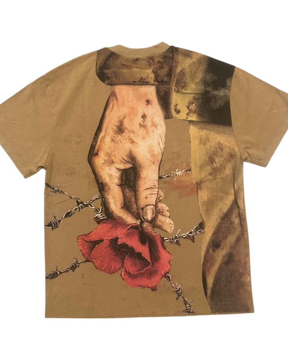 T-shirt with a graphic design of a hand holding a red flower amidst barbed wire on a beige background.