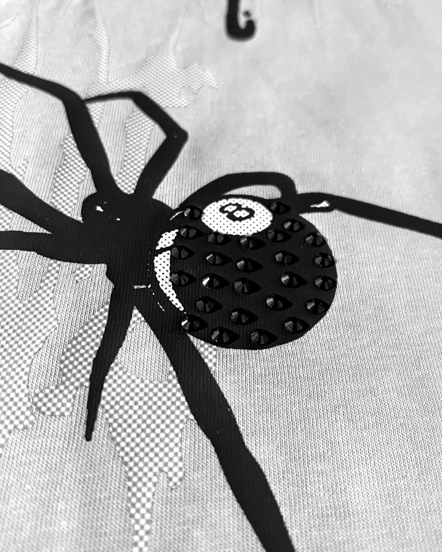 Black spider design on a grey background
