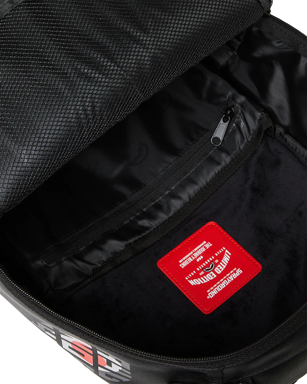 Black backpack with colorful branding on a white background by sprayground