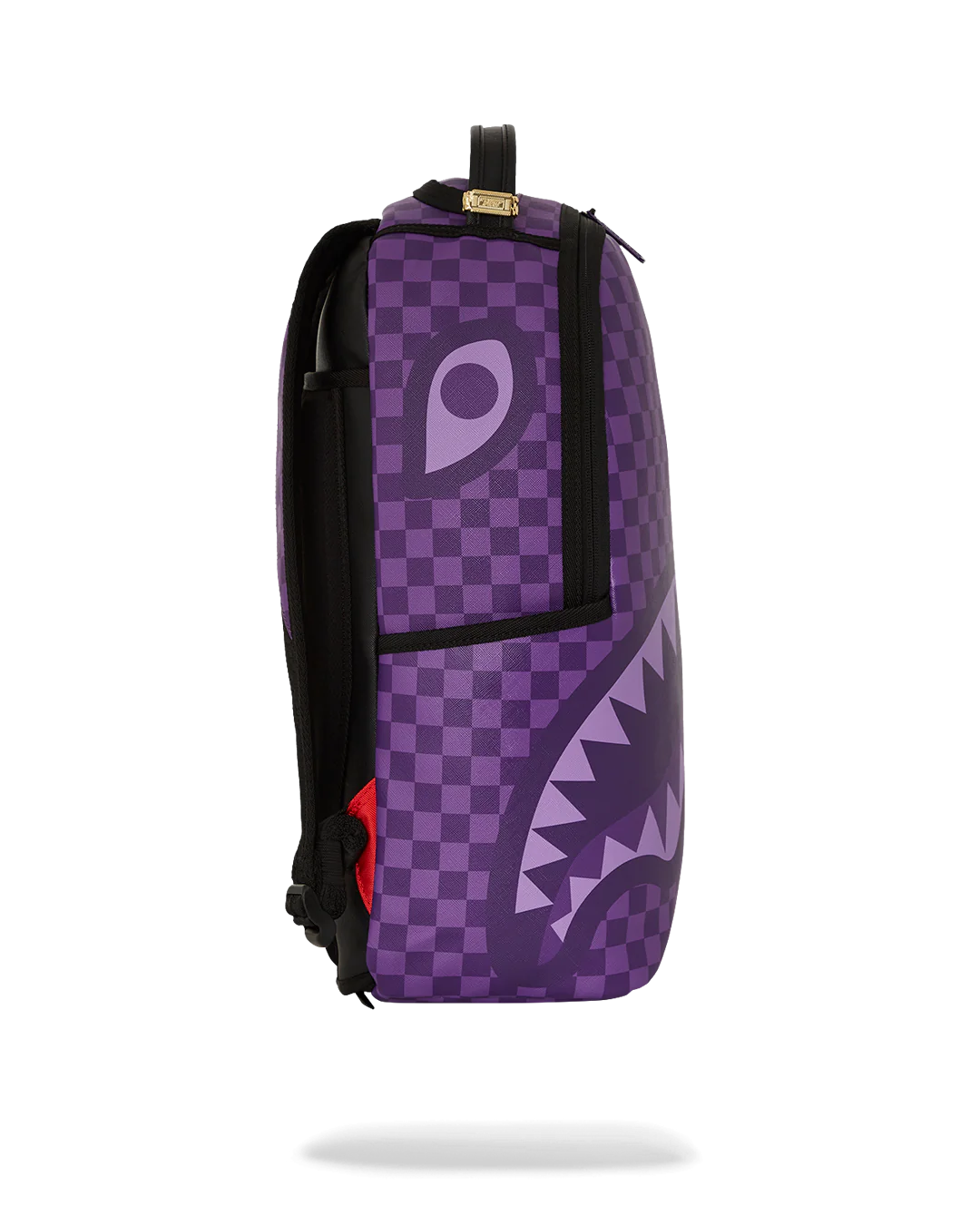 Purple checkered backpack with shark mouth design on a white background by sprayground