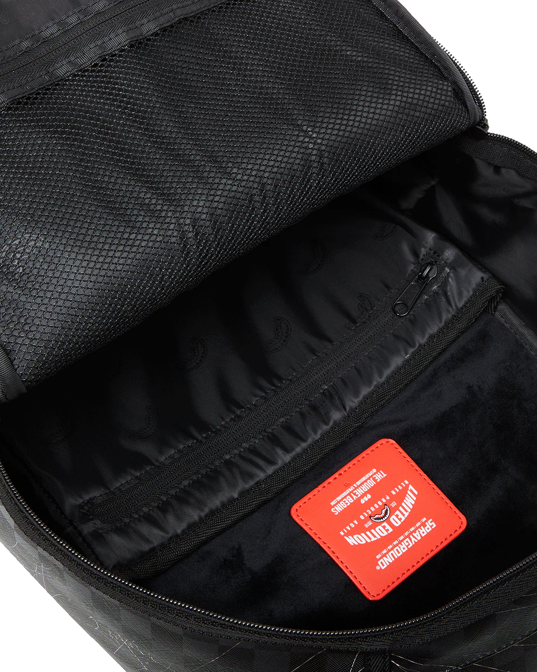 Black backpack interior with a red label on a white background