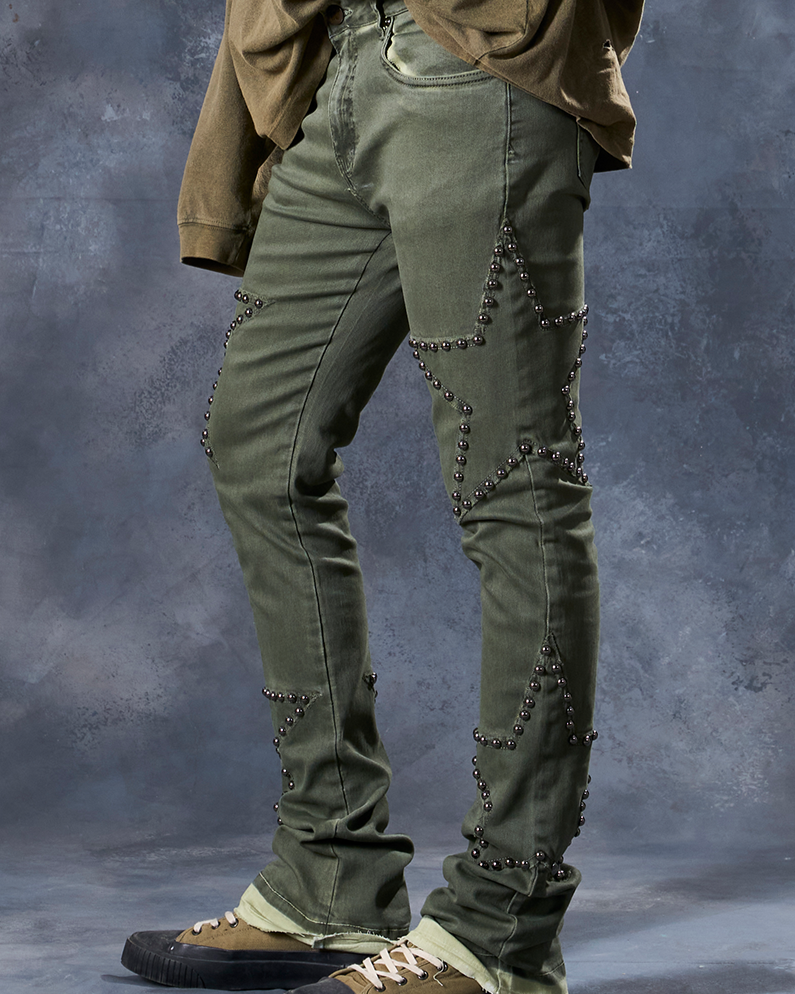 W by waimea star studded flare stacked jeans in olive green with silver-black metallic studs forming stars all over.