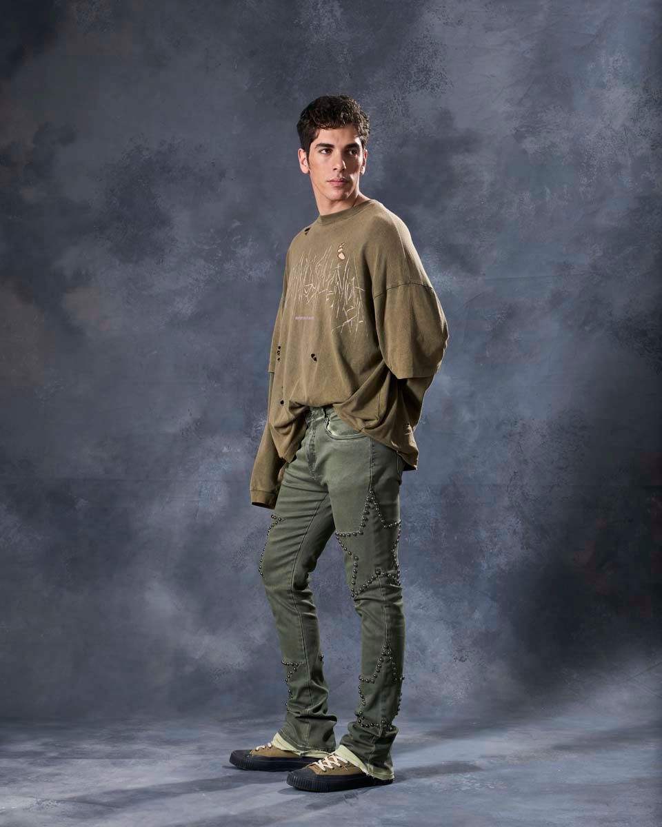 W by waimea star studded flare stacked jeans in olive green with silver-black metallic studs forming stars all over