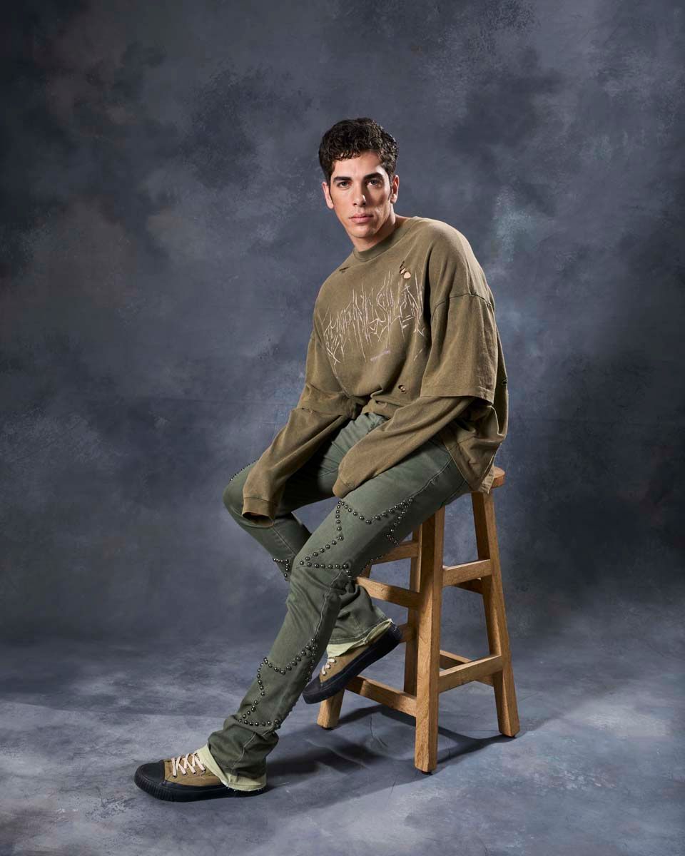 W by waimea star studded flare stacked jeans in olive green with silver-black metallic studs forming stars all over