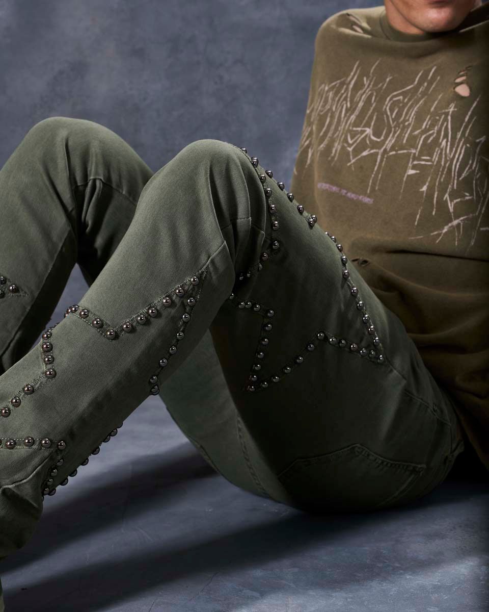 W by waimea star studded flare stacked jeans in olive green with silver-black metallic studs forming stars all over