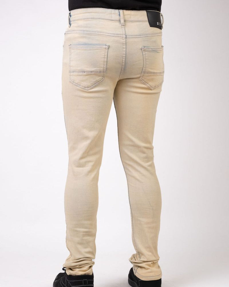 Beige jeans worn by a person on a white background