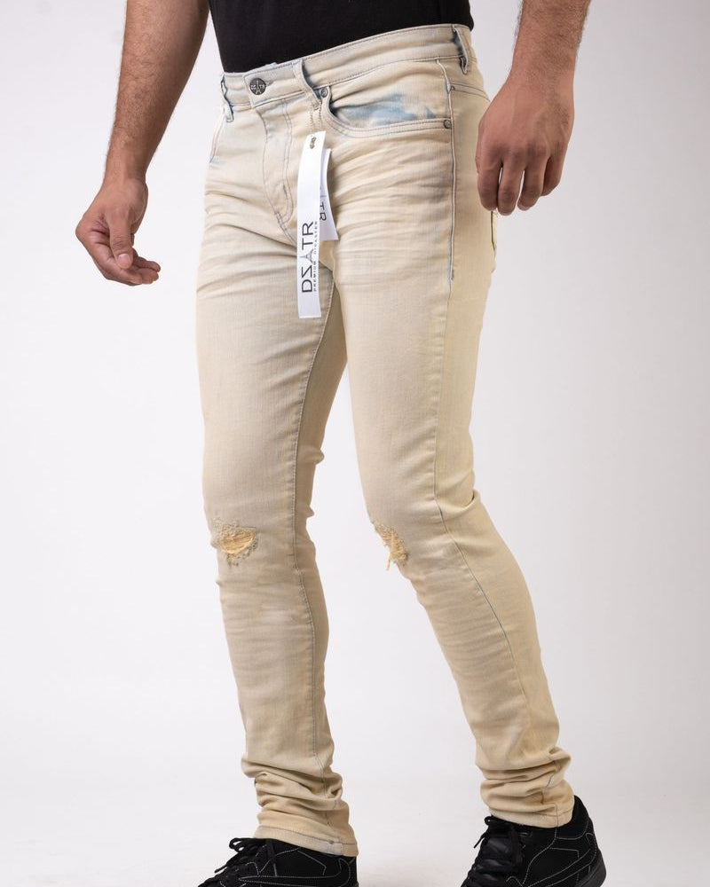 Beige jeans with a visible brand tag on a white background