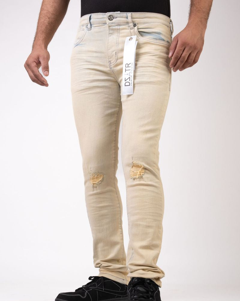 Beige jeans with visible branding on a white background
