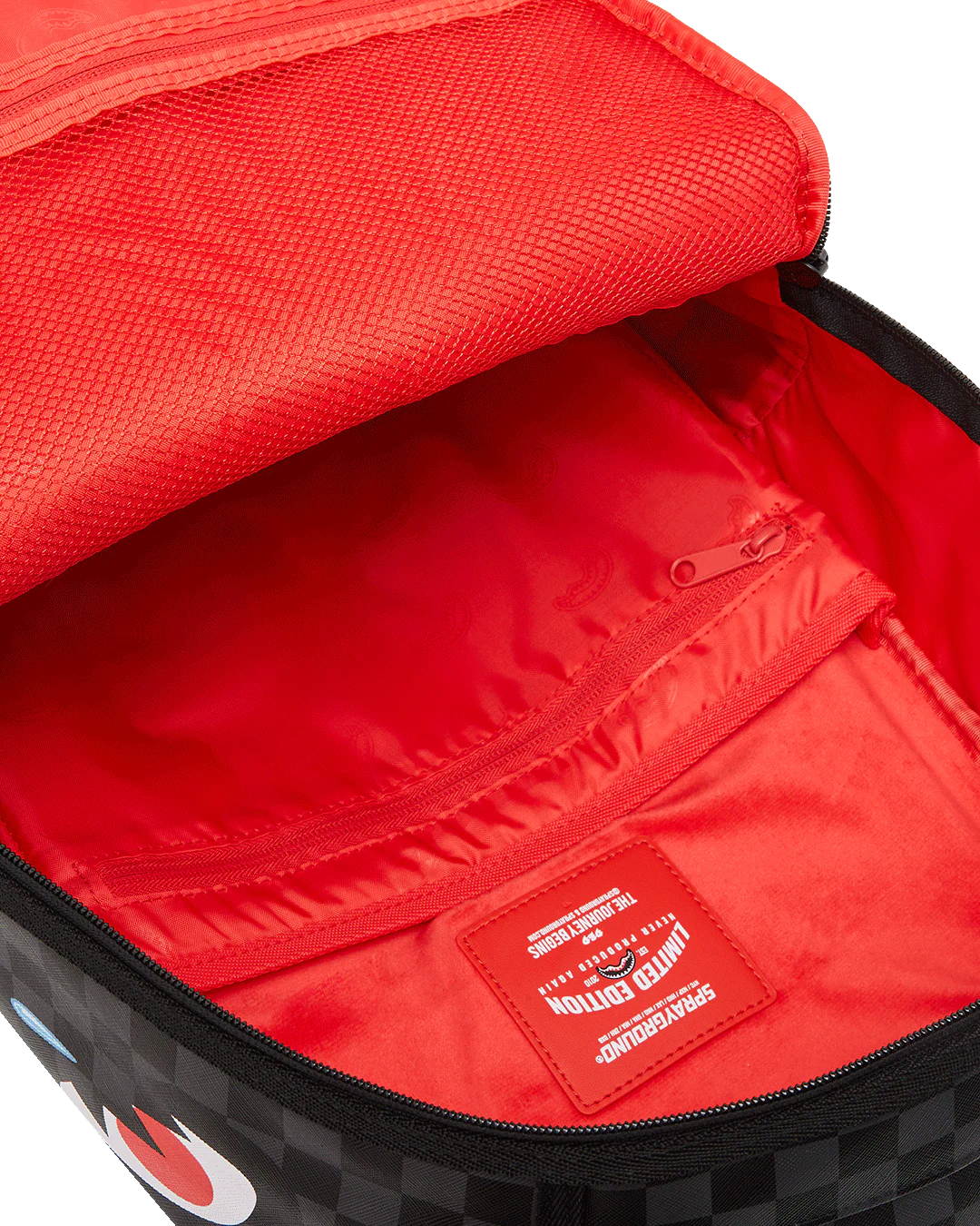 Red interior of a backpack with a visible brand label on a white background