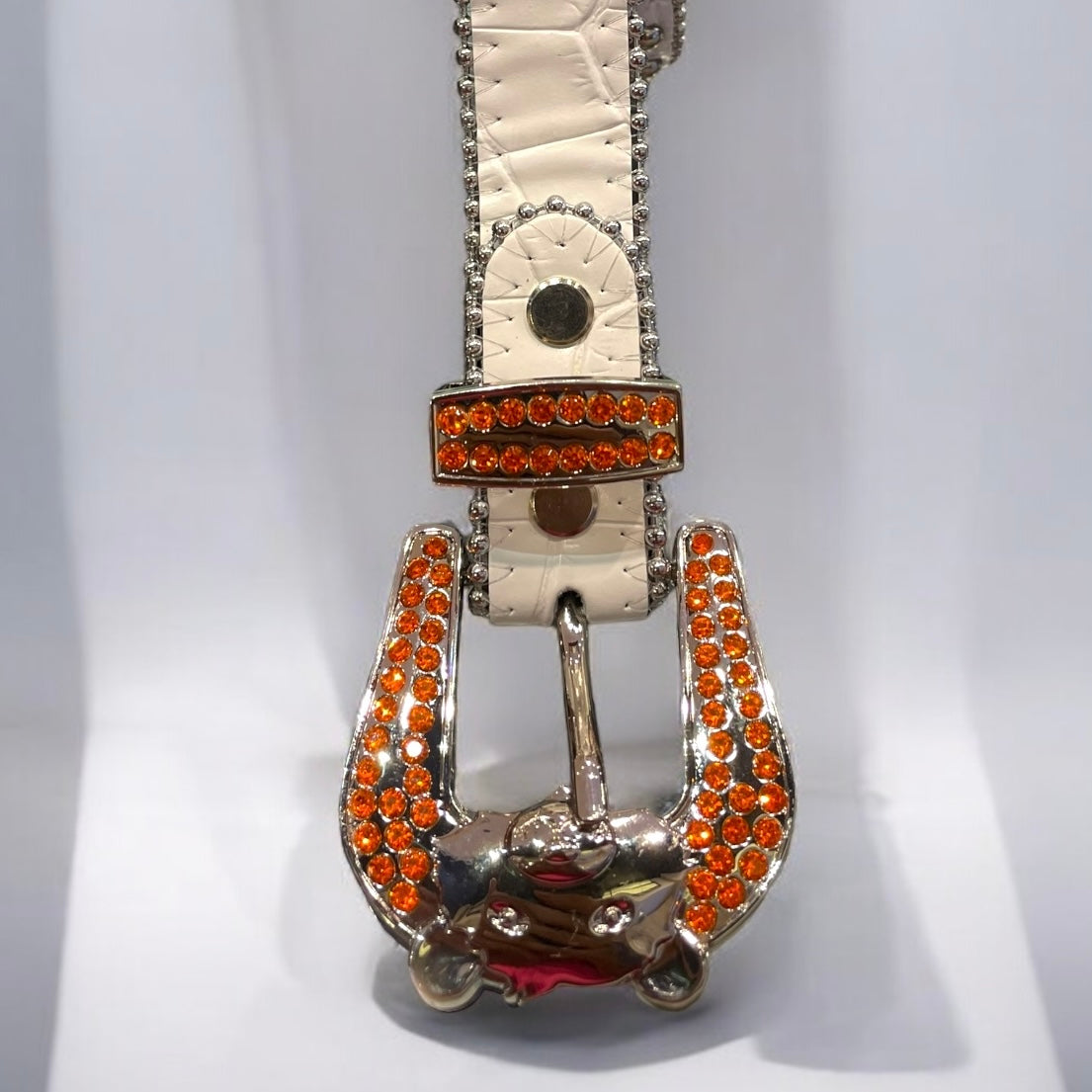 kids white leather belt with orange rhinestones.
