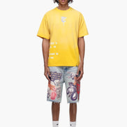 Person wearing a yellow t-shirt and colorful shorts on a white background