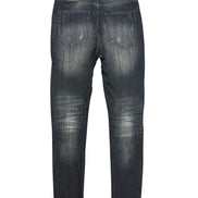 Back view of a pair of black distressed jeans on a white background