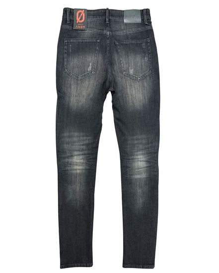 Back view of a pair of black distressed jeans on a white background