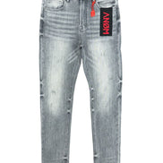 Gray distressed jeans with a brand label on a white background