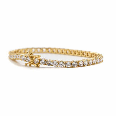 close up of the gold 5mm studded tennis bracelet on a white background 