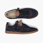 Pair of navy blue sneakers with brown soles on a white background