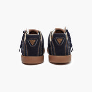 Pair of navy blue sneakers with brown soles on a white background