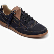 Navy blue sneaker with brown accents on a white background