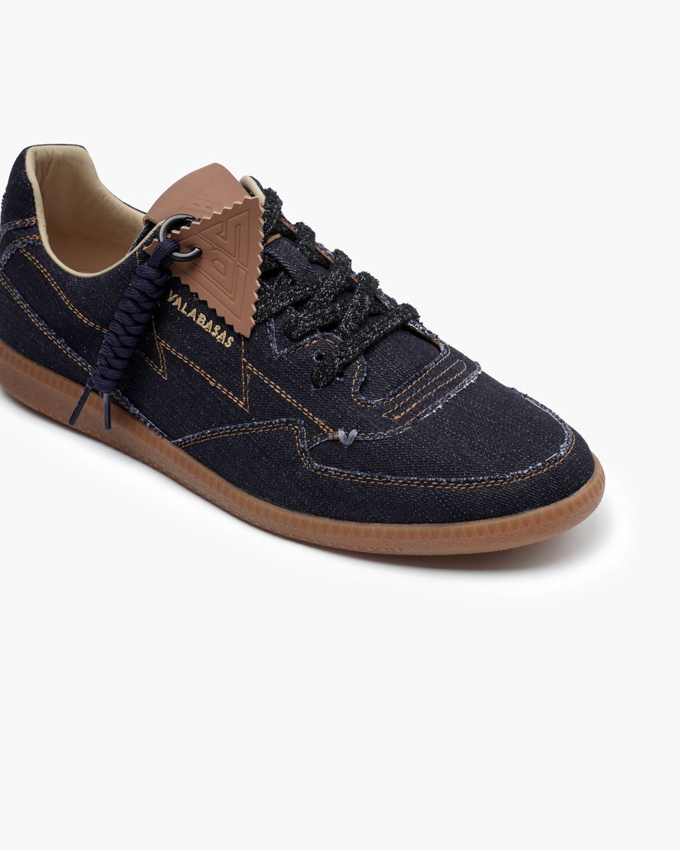 Navy blue sneaker with brown accents on a white background