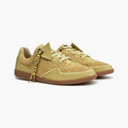 Pair of yellow sneakers with a white background