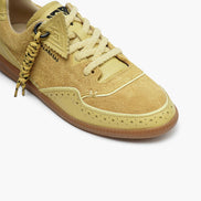 Beige sneaker with white laces on a white background