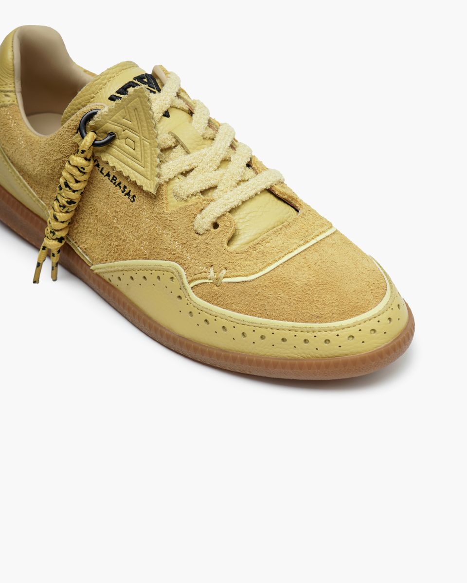Beige sneaker with white laces on a white background