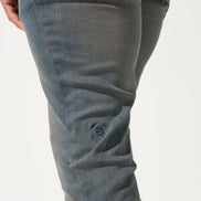 Close-up of gray pants on a white background