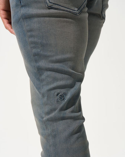 Close-up of gray pants on a white background