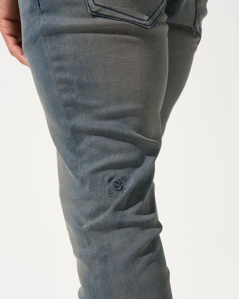 Close-up of gray pants on a white background