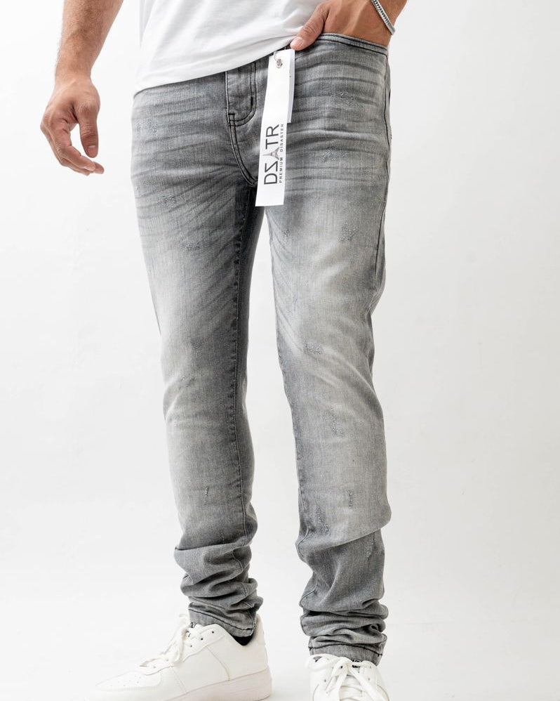 Person wearing gray jeans with a white label on a white background