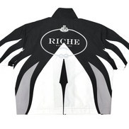 Black and white jacket with 'Riche' branding on a white background