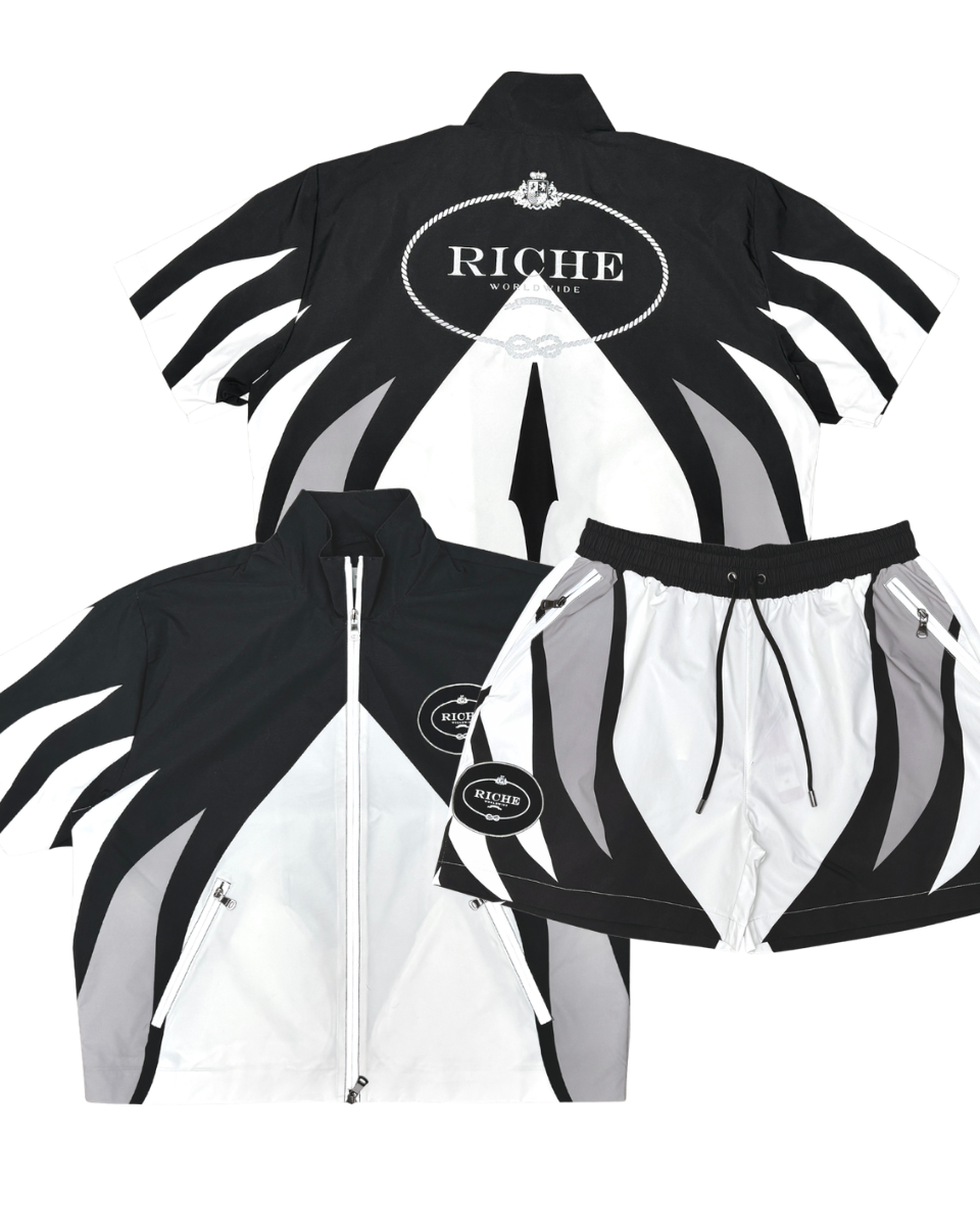 Black and white jacket with 'Riche' branding on a white background