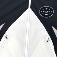 Black and white jacket with 'Riche' logo on chest
