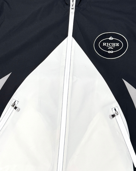 Black and white jacket with 'Riche' logo on chest