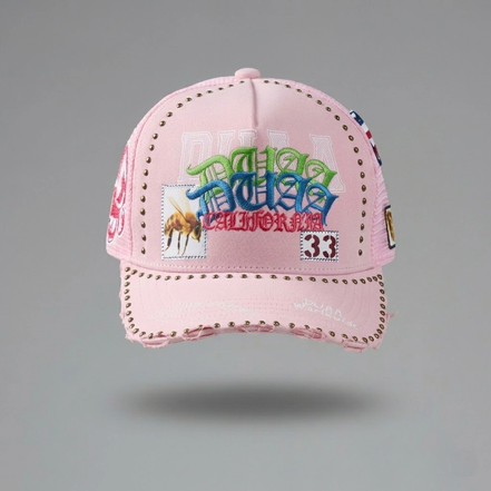 Pink cap with colorful text and graphics on a gray background