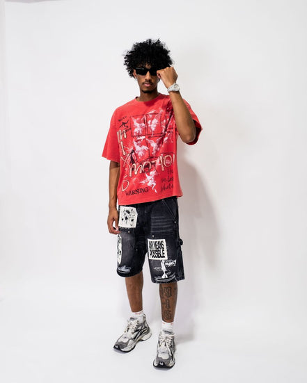 Person wearing a red graphic t-shirt and black shorts with white text on a white background