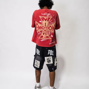 Person wearing a red t-shirt with graphic design and black shorts with white text on a white background